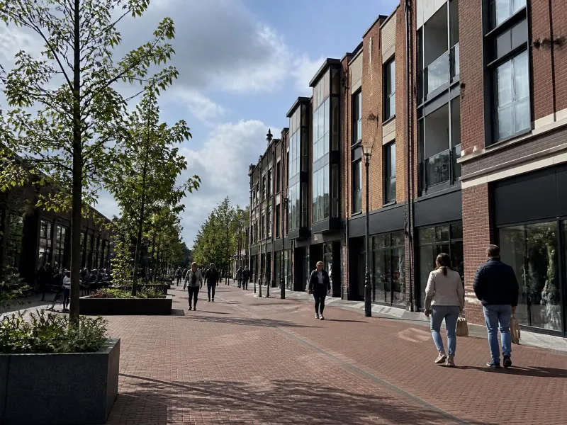 Modern pedestrian-friendly street in Berkshire with residential and commercial buildings, representing private transport coverage across the area.