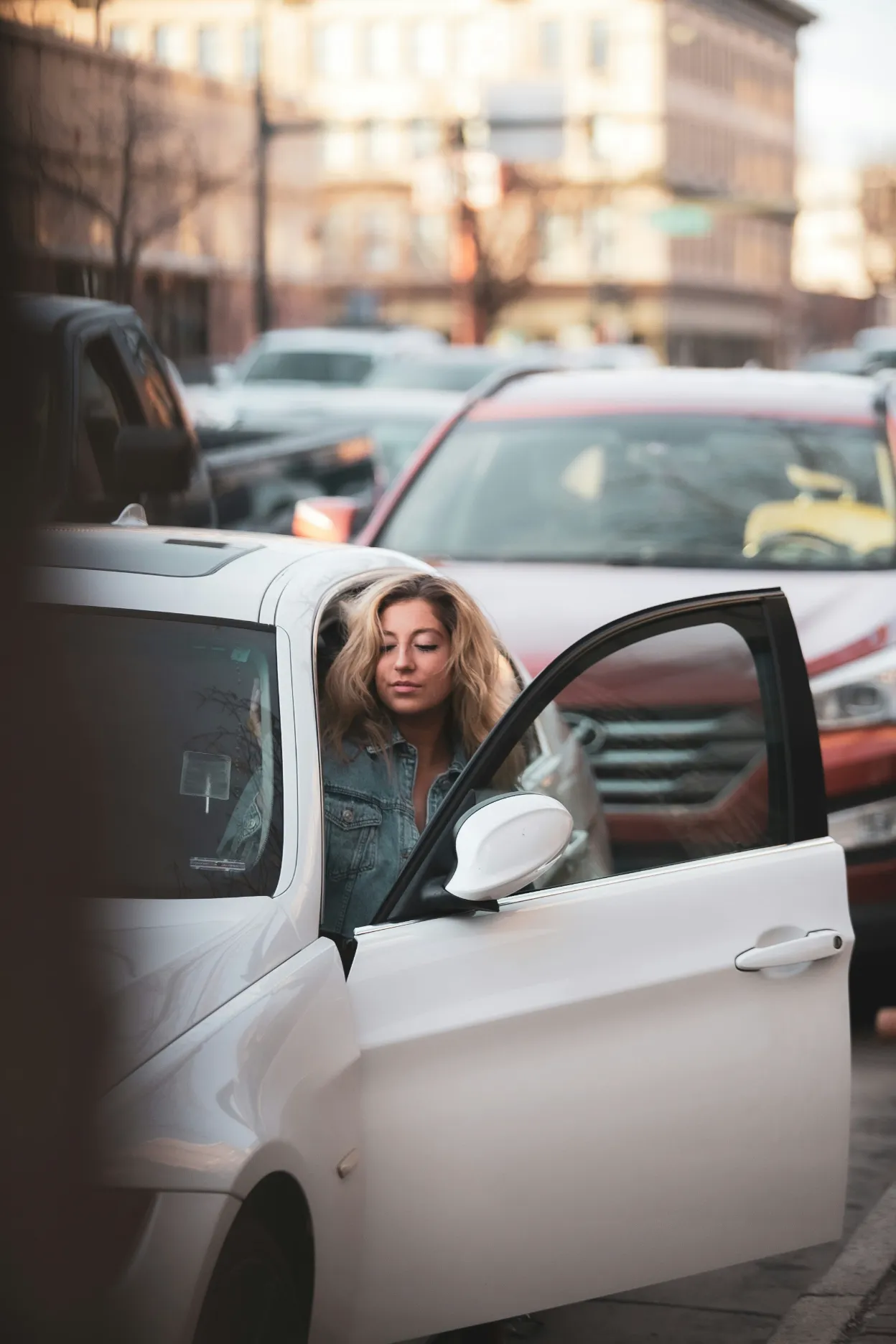 Passenger loading luggage into a private hire car for an airport transfer