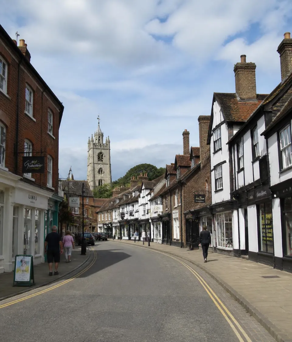 Traditional Buckinghamshire town street with historic buildings and church, representing private transport across Buckinghamshire
